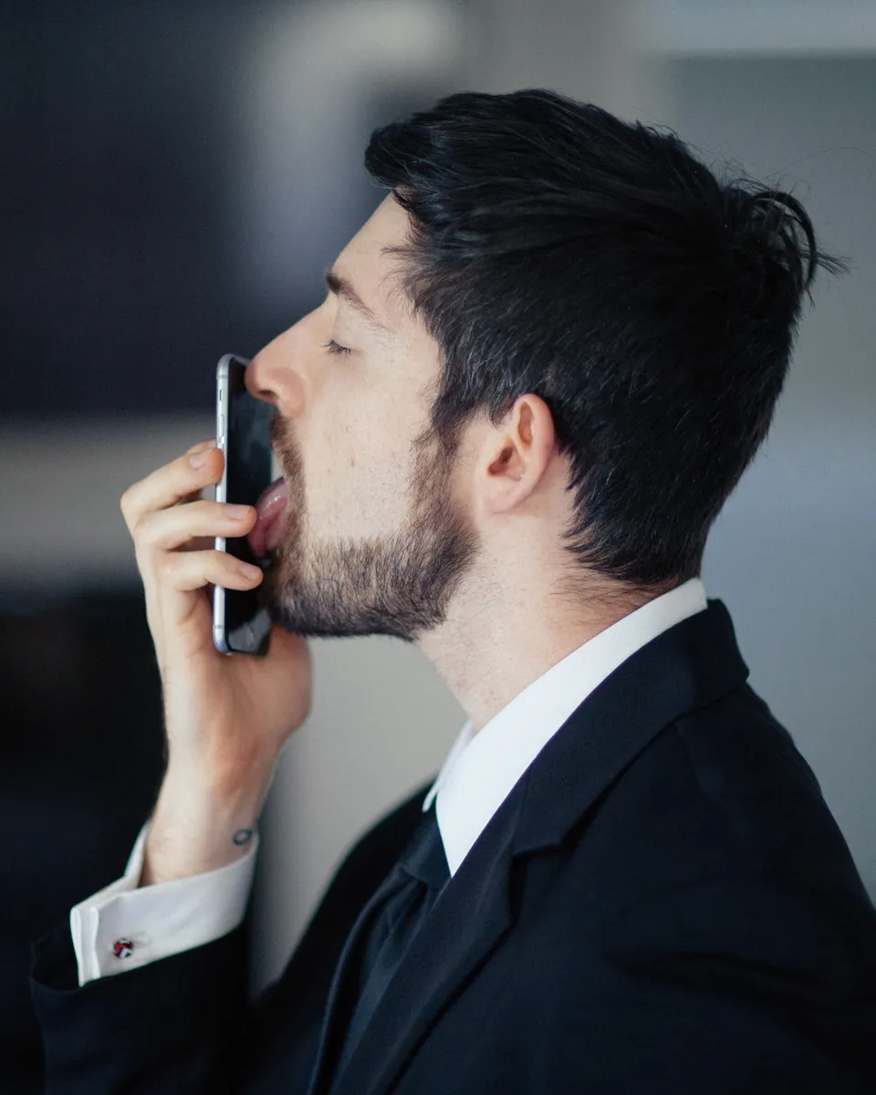 Man licking a phone